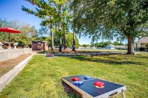 Relax on a full acre of yard with unique pine trees!