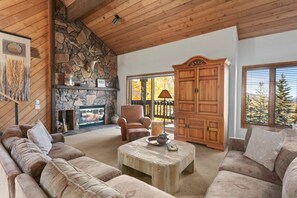 Warm yourself by the fire in the Floor to Ceiling Stone Fireplace
