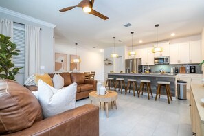 Open living space that seamlessly connects the beautiful kitchen and dining area, offering a perfect blend of comfort and style.