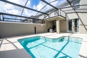 A spacious and comfortable outdoor pool area that is perfect for families looking for a relaxing vacation. The crystal-clear waters of the private pool are perfect for taking a refreshing dip, while the expansive patio area provides ample space for relaxation or activities. The screened structure overhead protects guests from insects while still allowing sunlight to filter thro...
