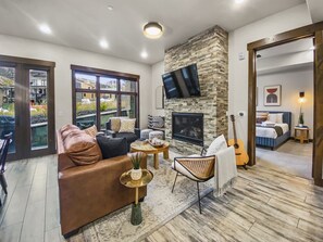 Cozy Living Room with Fireplace and Big Screen TV