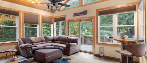 Step into our sunroom, a bright and inviting space that boasts a 55" Smart TV. 