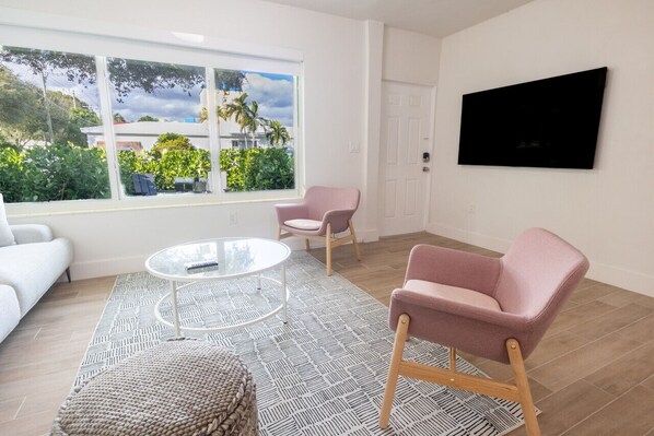 Living room with sofa, AC and TV
