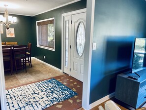 Front foyer view with adjacent dining and living areas/
