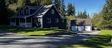 Main residence in the foreground, suite is above the garage in the background.