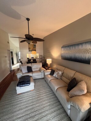 Living room with large ceiling fan.