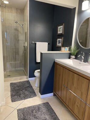 Master bathroom with tiled walk-in shower.