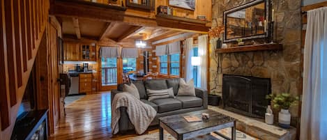 Inviting living room with queen size sleeper sofa and wood burning fireplace