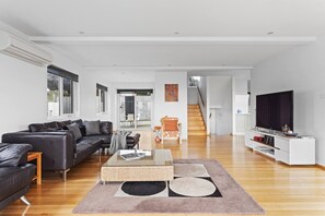 Upstairs, the light-filled living area provides comfortable sofas and a chaise where you can settle in with a movie, while also making use of board games, reading material and split system air-conditioning.
