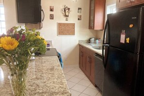 Fully equipped kitchen with full sized appliances. including dishwasher & stove.