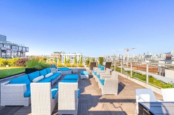 Relax on the rooftop lounge with panoramic city views.