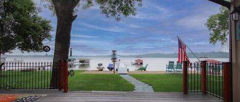 Nice flat back yard with a deck, firepit and sandy beach! Great for yard games!