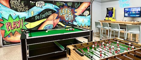 Our game room features arcade, video games, foosball, 3-in-1 game table, and many card games, completed with a mini-fridge, providing all you need for a delightful experience!
