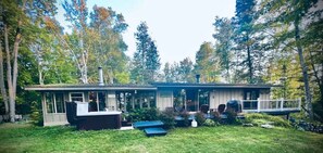 The back deck has panoramic views of the lake through the trees. 