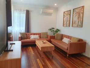 Lounge room in Spring / Summer Seasons with cool floorboards.