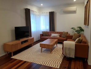 Lounge room with Air con, smart Tv and Nbn Wifi throughout the home.