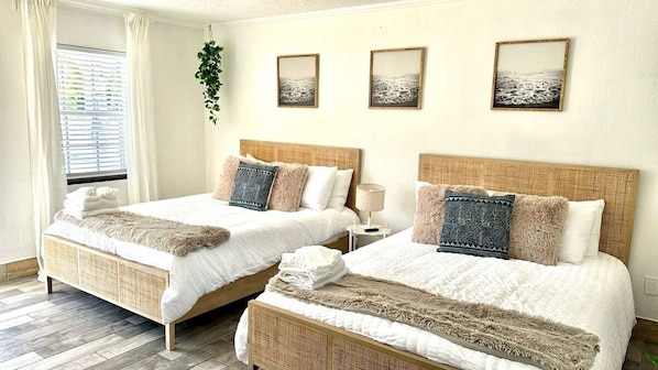 Lovely updated hotel style room with 2 Queen Beds, dining table, Mini fridge, smart TV, Kitchenette and private bathroom.