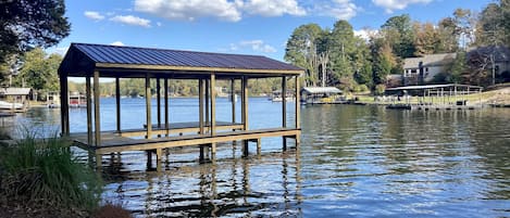 Single stall boat dock with large swim deck