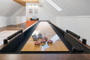 Shuffle board and turn table with vinyl records in the game room