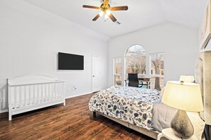 Spacious master bedroom with a TV and a workspace, ideal for insurance stays. After exploring local spots or dining at Umiya Sushi, relax in this comfortable room designed for productivity and rest.