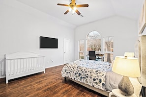 Spacious master bedroom with a TV and a workspace, ideal for insurance stays. After exploring local spots or dining at Umiya Sushi, relax in this comfortable room designed for productivity and rest.