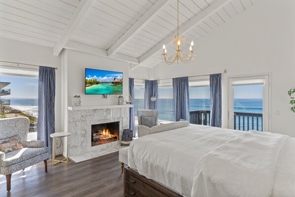 Oceanfront bedroom with a fireplace