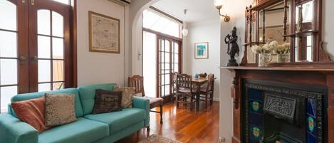 Original period details, vintage furnishings and local artwork adorn the living area.