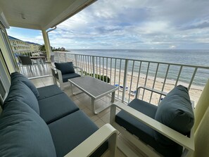 Only balcony with outdoor lounge area with sofa, 2 armchairs and cocktail table
