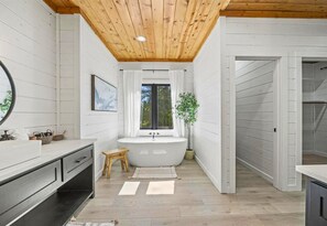 Bathe in elegance with a view, in a bathroom that marries rustic charm with modern luxury.