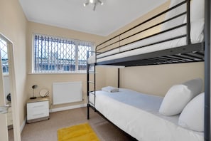 Bedroom 1 has a bunk bed, hangers, a mirror, and a hairdryer.