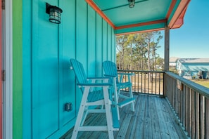 Covered porch with seating and bay views.