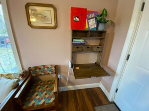 This is the desk area.  There is a conveniently located power hub mounted on the side for your use.  There are also a few books and games for your entertainment.