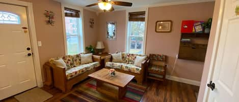 The living room viewed from the kitchen sink area.  Its a nice, cozy space to relax in.  That is the back door leading to your private deck and the backyard.