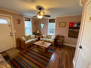 The living room viewed from the kitchen sink area.  Its a nice, cozy space to relax in.  That is the back door leading to your private deck and the backyard.