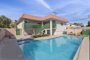 Spacious backyard with pool and outdoor dining.