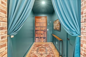 Entry hallway showcasing the "hidden" bookshelf door and 1930's inspired decor.