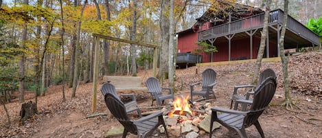 Backyard fire pit and rocking swing near stream 