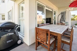 Dine outdoors using the barbecue and outside table.