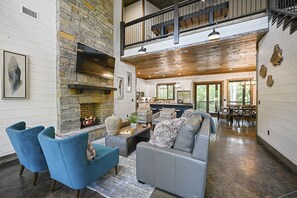 The open-concept living area is a haven for the family to hang out in front of the warm fireplace. 