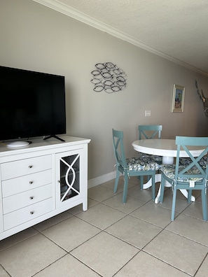 Smart TV with cable and dining area.