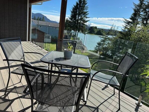 Covered outdoor living area with a river view.