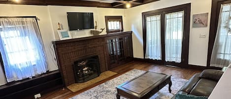 Living area with gas fireplace and original built ins