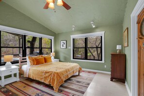 Large windows flood the bedroom with plenty of natural lighting