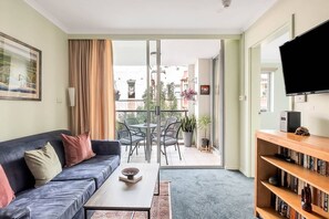 Sliding glass doors from the living area open out to a private balcony.
