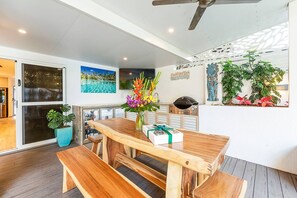 A crafted, timber picnic table invites your group to dine alfresco style beside the pool.
