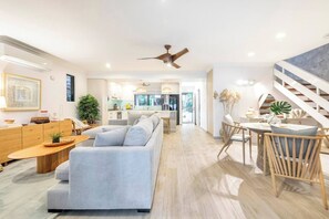 Enjoy the stylish open-plan living area with the gentle breeze of a ceiling fan and the comfort of air conditioning—where relaxation meets sophistication.