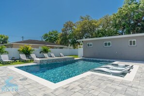 Plenty of seating for everyone as you lounge around the elegant pool with sun shelf, elevated water feature, and spacious hardscape for fun in the sun. 