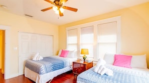 The room is beautifully furnished with cosy beds and a ceiling fan, making your stay more pleasant.