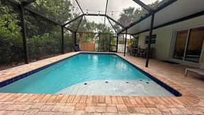 The outdoor heated pool has a tanning ledge