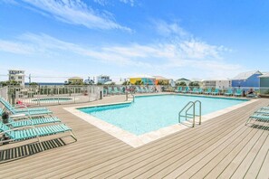 Elevated pool with expansive sun deck and kiddy pool offering Gulf views. 